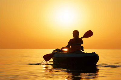 Kayak and sunset on the coast